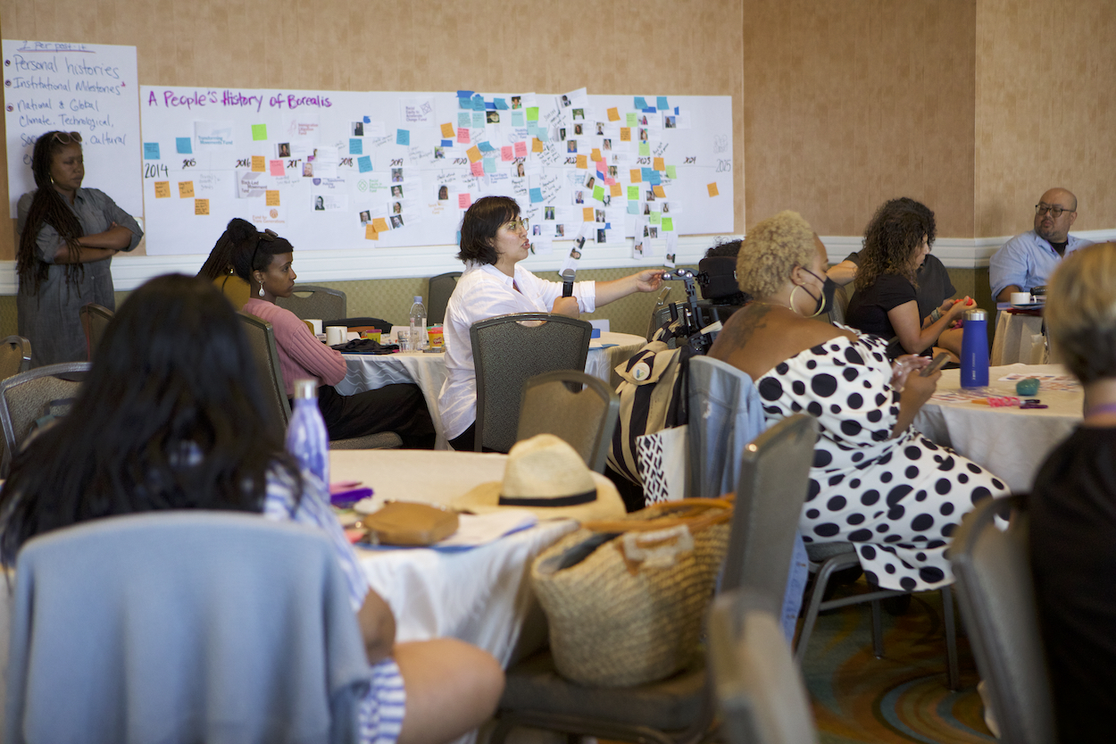 Women speaking with microphone in a classroom setting